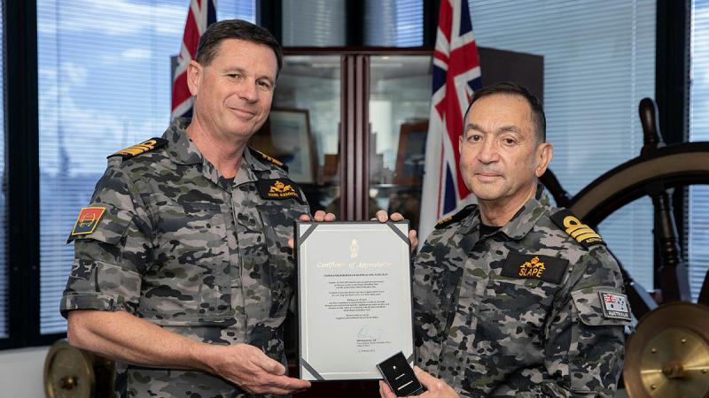 Chief of Navy, Vice Admiral Mark Hammond, presents a Federation Star to Commander Bertram Slape, marking 50 years’ service in the Royal Australian Navy. Photo: Petty Officer Christopher Szumlanski