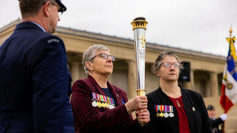 Representatives and descendants of war veterans carry the torch during the opening ceremony of the Legacy Centenary Torch Relay at the Pozieres British Cemetery, France.