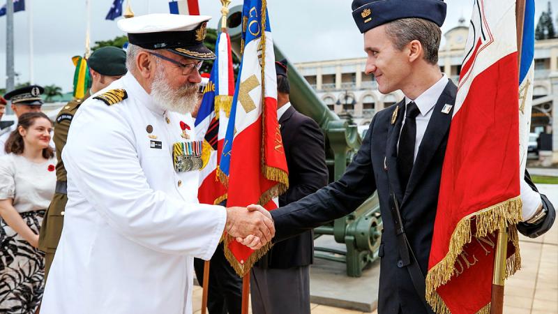 ADF Contingent Commander for Exercise Croix Du Sud, Captain John Cowan, RAN, shakes the hand of a French Armed Forces in New Caledonia Flag Bearer. Photo: Corporal Dustin Anderson