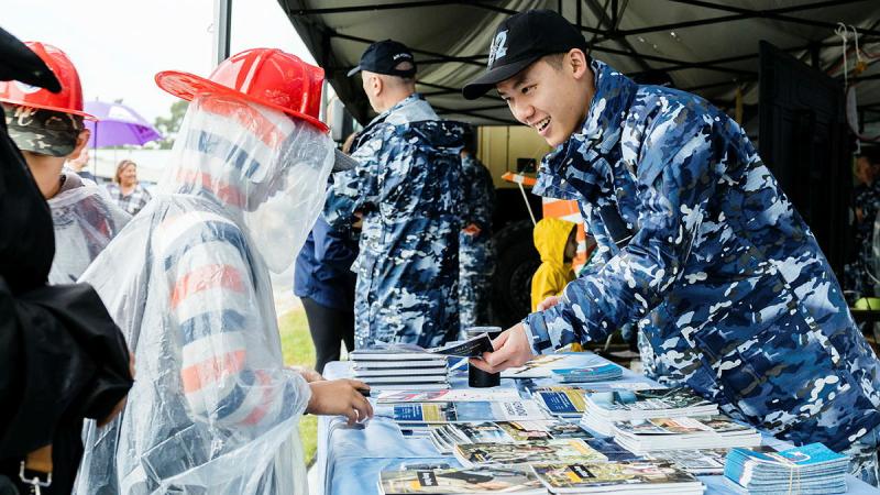 An aviator from 22 Squadron provides Air Force trivia to visitors during the Hawkesbury Show at Clarendon, NSW. Photo: Corporal John Solomon