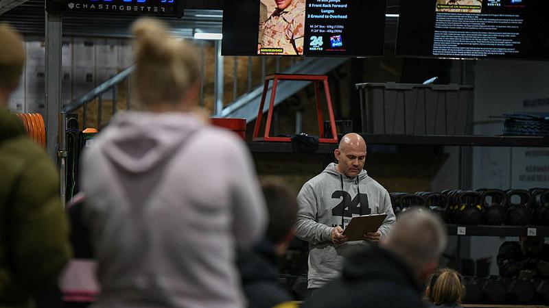 CrossFit CMA Wodonga owner, Zak Rogers, reads the biography of a fallen soldier before the workout begins at the 24 Hours of Heroes fundraiser for Wounded Heroes. Photo: TrewBella Photography