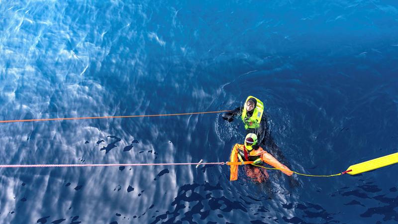 HMAS Anzac Swimmer of the Watch, Able Seaman Mitchell Donovan conducts a rescue swim during a man overboard exercise as a part of Exercise Bersama Shield. Photos: Leading Seaman Jarryd Capper