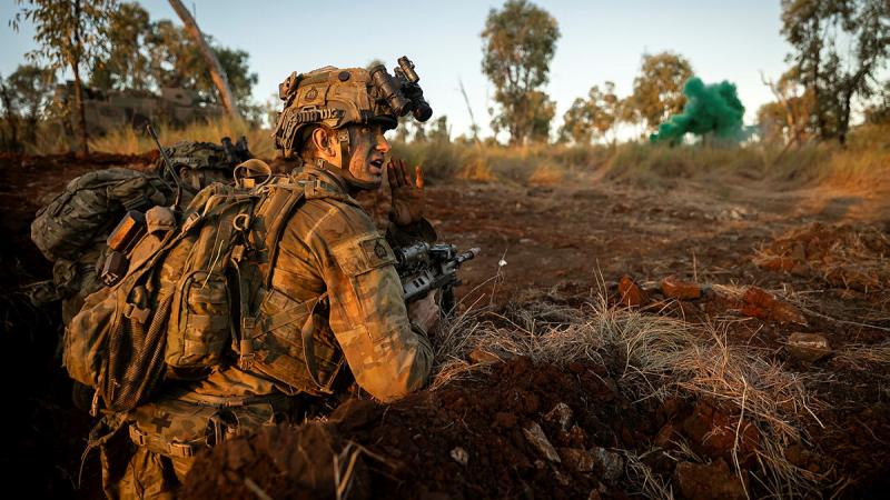 A soldier from 3rd Battalion, The Royal Australian Regiment gives orders during an assault on the enemy main defensive position during Exercise Brolga Run at Townsville Field Training Area. Photo: Lance Corporal Riley Blennerhassett