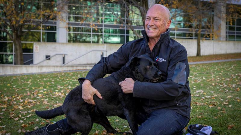 Michael Nobes, a former Navy clearance diver, and his assistance dog Lola outside Russell Offices, Canberra, for a fundraising and awareness barbeque to support Defence Community Dogs. Photos: Corporal Jacob Joseph