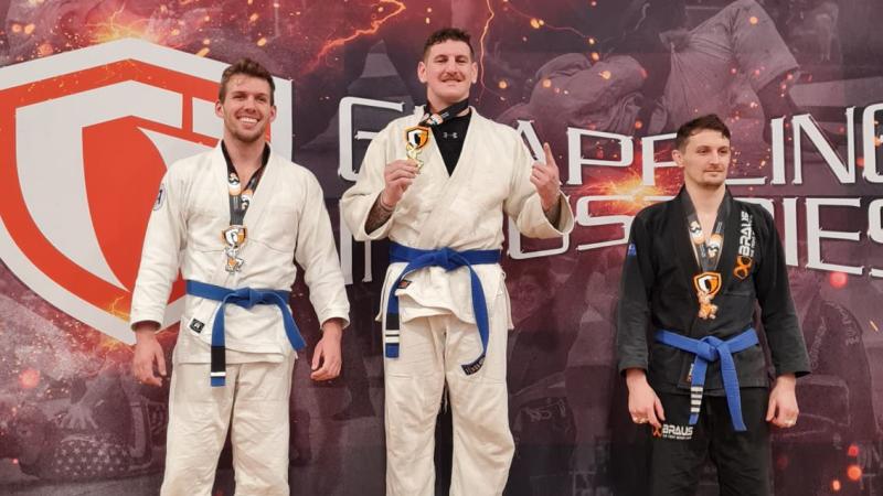 Australian Army officer Captain Dylan Voncina on the podium during the Grappling Industries Brazilian jujitsu gi and nogi round robin tournament in Melbourne.