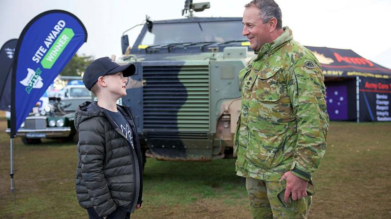 Lieutenant Oliver Breeze of 2nd Force Support Battalion chats with Austin outside the Army display at Agfest in Tasmania.