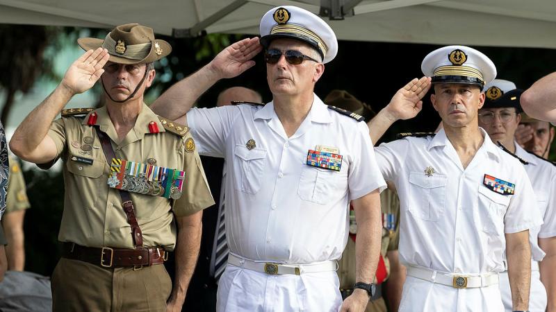 From left, Commander of the Combat Training Centre Colonel Benjamin McLennan, Captain of French Ship La Fayette Capitaine Jean and Captain of the French Ship Dixmude Capitaine Emmanuel salute during a wreath-laying ceremony in Townsville. Photo: Lance Corporal Riley Blennerhassett