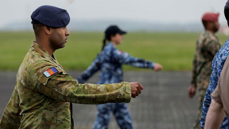 ADF personnel Bombardier Michael Nona and Corporal Tegan Ross march during a rehearsal for the King's Coronation at RAF Odiham, UK. Photo: LACW Emma Schwenke