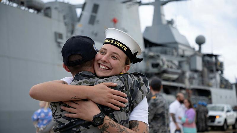 Seaman Genevieve Heibloem greets a friend on HMAS Perth's return to Fleet Base West in Western Australia. Photo: Able Seaman Rikki-Lea Phillips