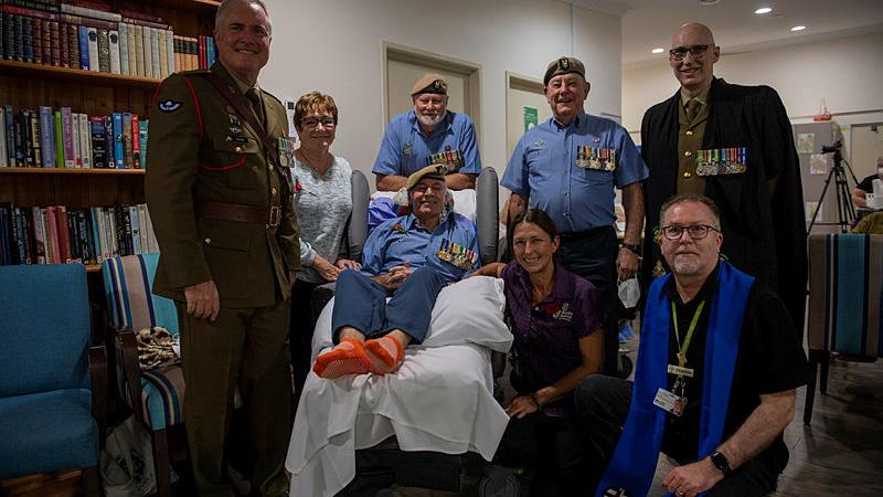 Warrant Officer Class One (retd) Allan Forsyth, centre, with family, friends after the Anzac Day ceremony Army's 7th Brigade conducted in his honour.