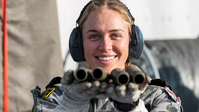 Leading Seaman Esther Melvin holds 25mm Typhoon shells following a live-fire activity on HMAS Canberra as the ship makes its way to Exercise Talismans Sabre in 2021. Photo: Leading Seaman Sittichai Sakonpoonpol