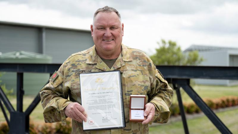 Warrant Officer Class Two Andrew Payne, of 6th Engineer Support Regiment, with the Federation Star clasp to his Defence Force Long Service Medal and a Certificate of Appreciation in recognition of 40 years of service to the ADF. Photos: Warrant Officer Class 2 Kim Allen