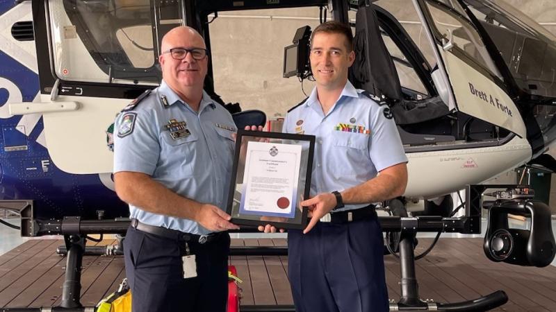 Flight Sergeant William Gill is presented with a Queensland Police Assistant Commissioner’s certificate by Assistant Commissioner Brian Codd. 