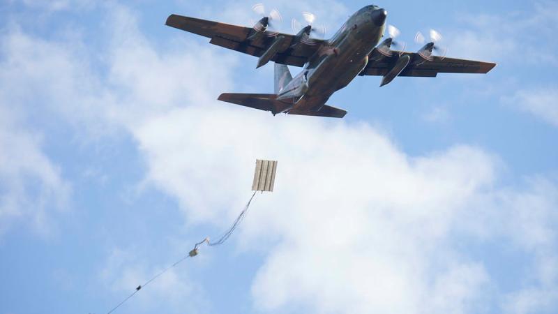 A Republic of Singapore Air Force C-130H Hercules drops a heavy equipment platform. Photos: Aircraftwoman Maddison Scott
