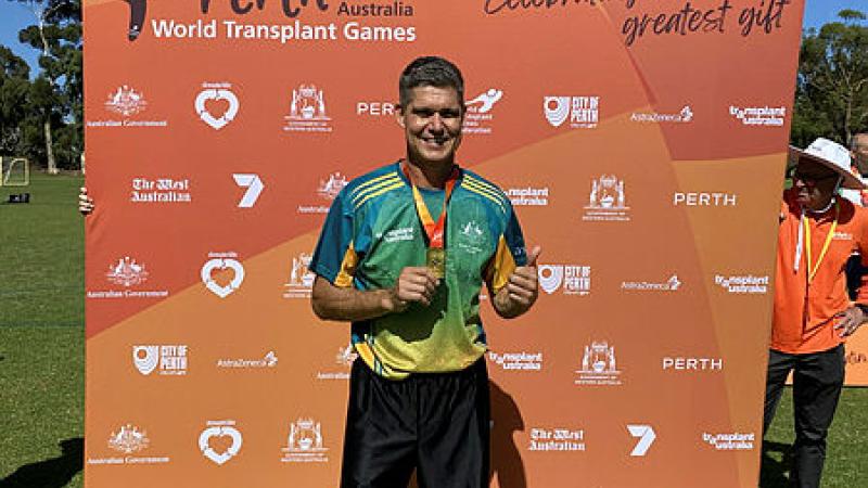 Squadron Leader Mark Oksanen wearing the gold medal he won in soccer at the 2023 World Transplant Games.