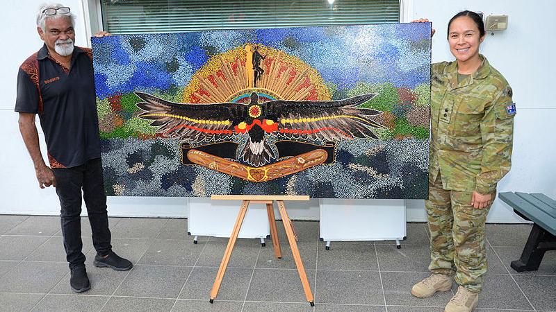 Uncle Allan Charles Lena and his artwork at Kokoda Barracks, with Lieutenant Colonel Alana Burkitt.