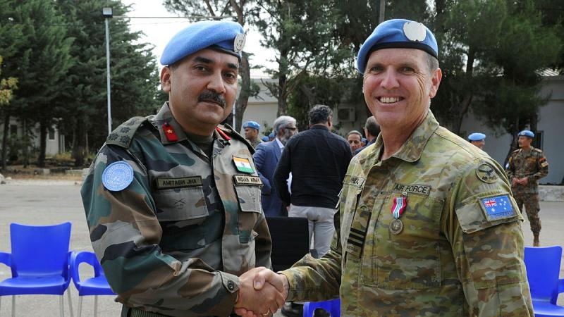 Wing Commander Stuart Wheal, is congratulated by Deputy Force Commander Brigadier General Amitabh Jha (Indian Army) after receiving the UNDOF medal. Photo: Major Shobit Bahadur Chand (Nepali Army)