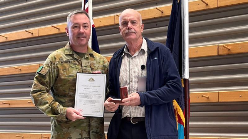Major Richard Stanworth poses with his third Federation Star medal and Certificate of Appreciation marking 50 years service with the Army, presented by Major General Scott Winter at Gallipoli Barracks, Queensland. Photo: Captain Peter Nugent