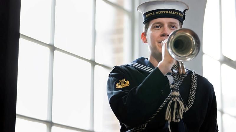 Able Seaman Musician Phillip Eden sounds the Last Post during a memorial service to mark the 81st anniversary of the sinking of HMAS Kuttabul at Garden Island, New South Wales. Photos: Leading Seaman Matthew Lyall