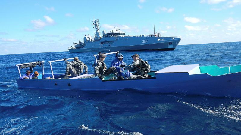 ADV Cape Capricorn’s boarding officer, Lieutenant Michael Loudon, issues a notice of legislative forfeiture to personnel on a foreign fishing vessel.