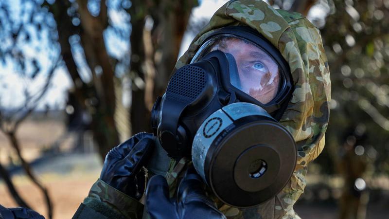 Staff Cadets of the Royal Military College - Duntroon conduct a buddy check during Chemical Biological Radiological and Nuclear (CBRN) Training on 15 June 2023 at Majura Training Area. Photos: Sergeant Sagi Biderman