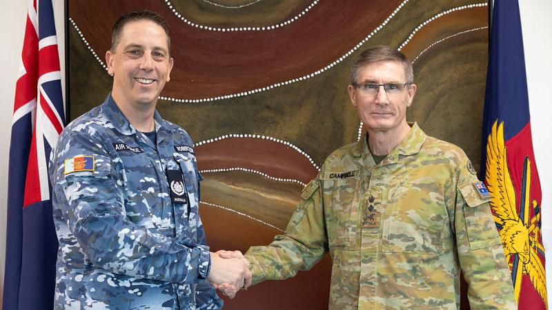 Chief of the Defence Force General Angus Campbell congratulates Warrant Officer Ken Robertson on his new role. 