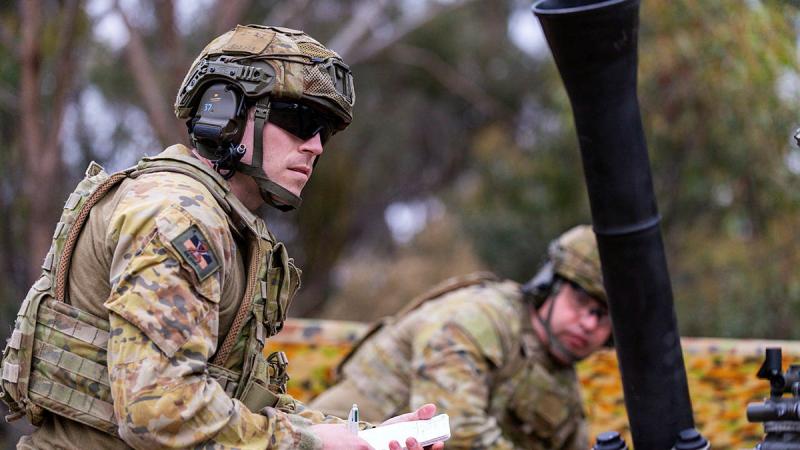 A soldier from the 5th/6th Battalion, the Royal Victoria Regiment prepares to record firing orders next to an 81mm mortar at Puckapunyal training area, Victoria. Photos: Corporal Michael Currie