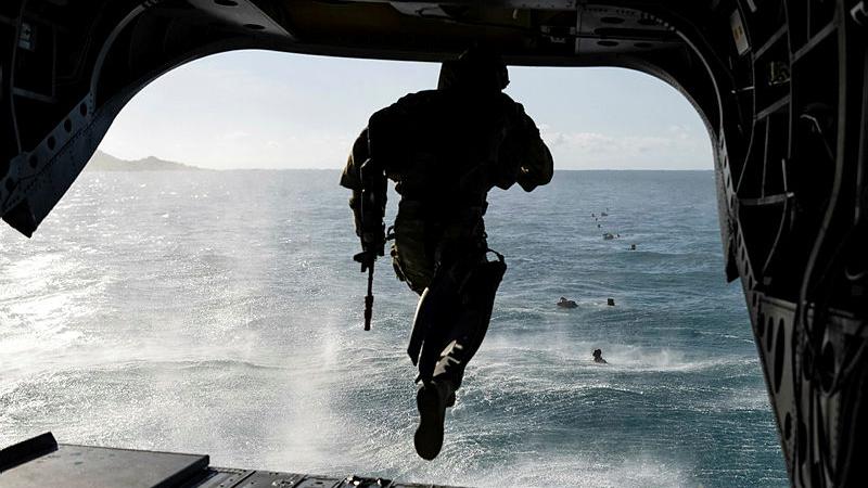 An Australian Army soldier from 2nd Battalion, The Royal Australian Regiment jumps from a Boeing CH-47 Chinook during a helocasting serial as part of Exercise Sea Explorer. Photo: Able Seaman Rikki-Lea Phillips