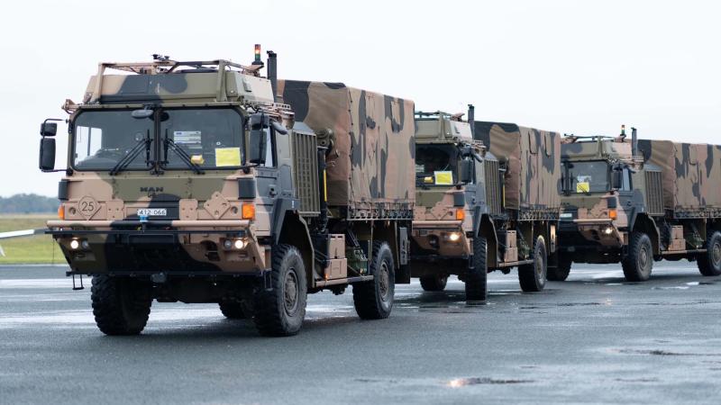 Three autonomous Army trucks ready for the Leader-Follower trial. 