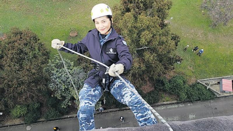 Leading Aircraftswoman Jill Magno abseils down the side the side of a building
