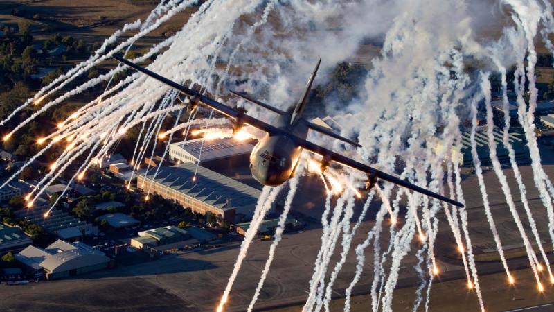 A C-130J Hercules throws flares during training