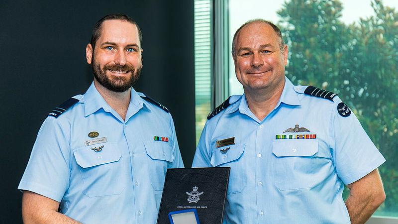RAAF Flight Lieutenant Sean Wrigley receives a Chief of Air Force Gold Medal Commendation from Director of Aviation Operations, Group Captain Chris Pouncey at Fairbairn, ACT. Photo: Leading Aircraftman Ryan Howell