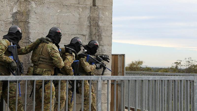  Army reservists from the 5th Brigade conduct an entry drill using airsoft rifles at Holsworthy Training Area at the end of Exercise Arras Sprint.