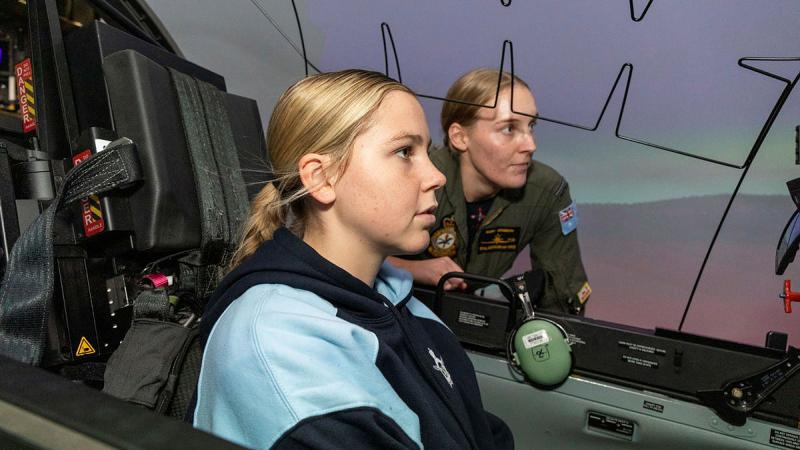 2 Flight Training School trainee Pilot Officer Gabrielle Adamson takes Air Force Indigenous Youth Program participant Indiana Baines through the paces of a Pilatus PC-21 simulated flight at RAAF Base Pearce, WA. Photos: Flying Officer Michael Thomas
