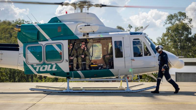 Australian Army soldiers sit in a Toll Bell 412 helicopter