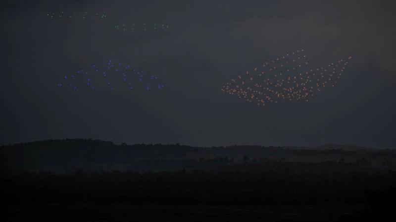 Drones flying above an enemy position demonstrate in concept surveillance (green), electronic warfare (blue), and attack (orange) capabilities during a human-machine team exercise at Puckapunyal Military Area. Photos: Sergeant Matthew Bickerton