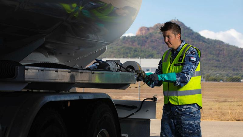 Corporal Hannah Graham a winds in the earthing cable before heading out to refuel. Photos: Leading Aircraftman Ryan Howell