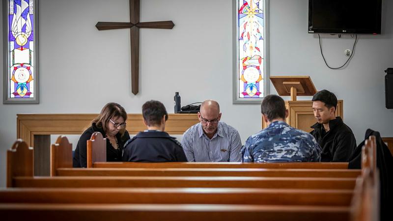 Samuel Hays (centre) leads the National Day of Prayer for Defence at Saint John's protestant chapel at RAAF Base Williamtown. Photo: Corporal Melina Young