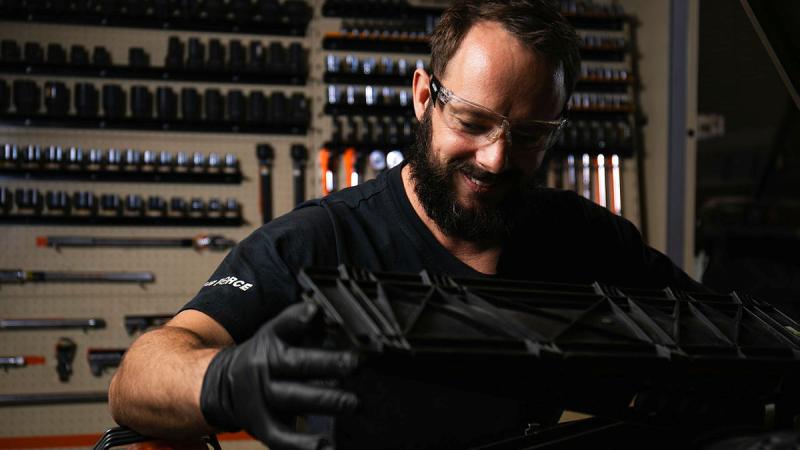 Leading Aircraftman Harry Williamson a ground support equipment technician from 27 Squadron works in the engine bay of a G-Wagon at RAAF Base Townsville. Photo: Leading Aircraftman Ryan Howell