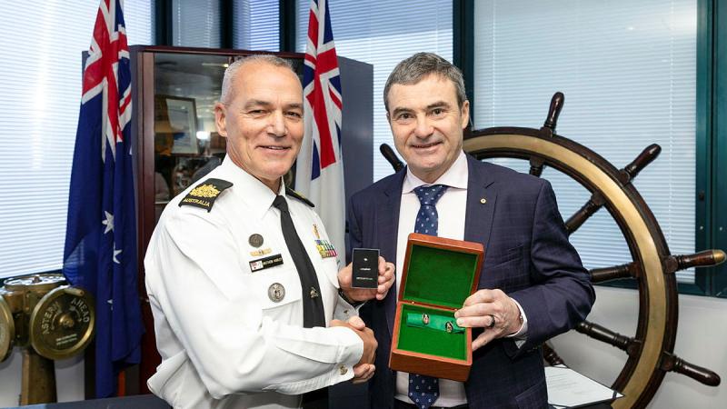 From left, Rear Admiral Michael Rothwell (retd) presents Command Warrant Officer Matthew Hurley, with his Federation Star marking 40 years of service in the Royal Australian Navy during a small ceremony at Fleet Headquarters in Sydney. Photo: Leading Seaman Matthew Lyall