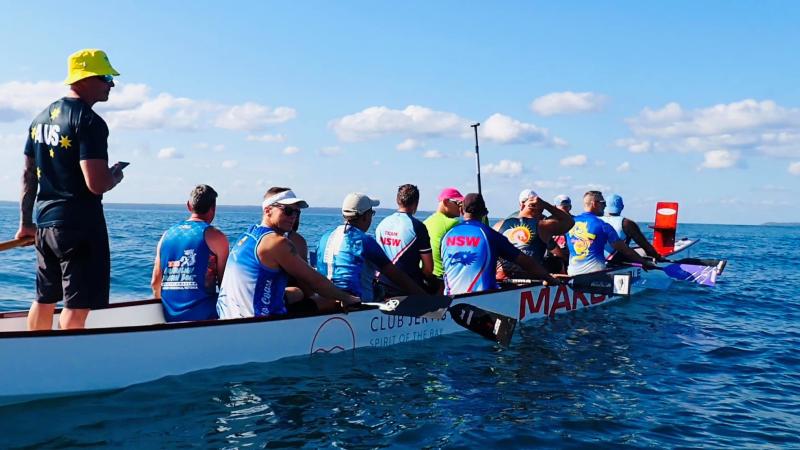 Athletes in a dragon boat paddling