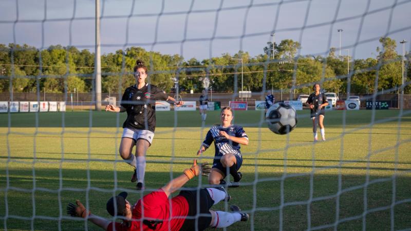 Petty Officer Jessica Gunning scores a goal during a soccer match.