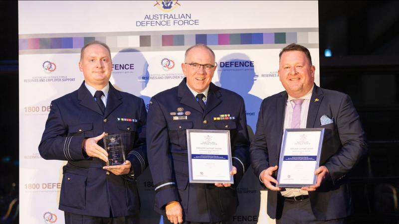 Squadron Leader Nathan Hook, left, with Acting Head Joint Support Services Division Air Commodore Grant Pinder, and civilian employer David Zemel from AeroPM. Photo: Hilary Wardhaugh