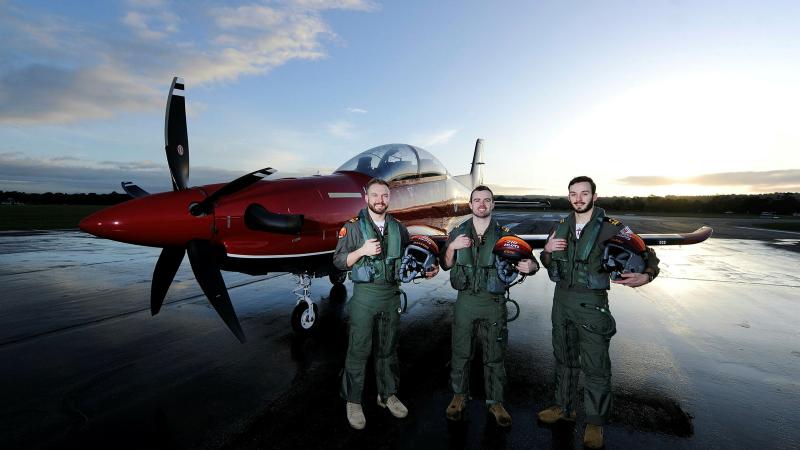 270 ADF Pilots' Course graduates (l-r) Lieutenant Michael Harrigan, Lieutenant Gregory Cook, and Lieutenant Harrison Coldwell pose for a photo at dawn on the flight line with a Pilatus PC-21 aircraft at RAAF Base Pearce in WA. Photos: Chris Kershaw