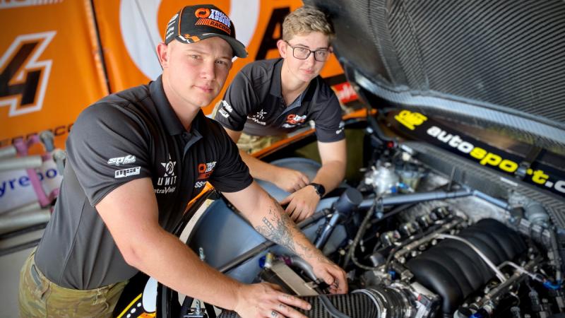 Australian Army vehicle technicians Craftsmen Thomas Noble and Layla Williamson from 5th Aviation Regiment check the engine of a Matt Stone Racing Chevrolet Camaro Supercar
