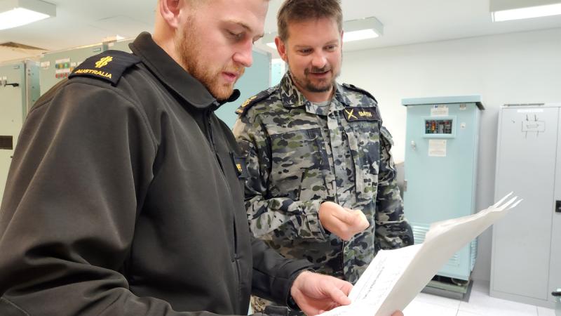 Lead communications technician instructor Petty Officer Christopher Smyth instructs Able Seaman Caleb Pope