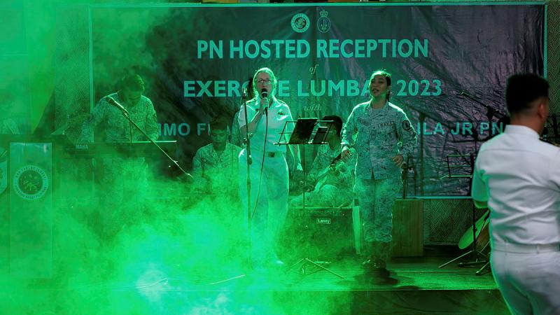 HMAS Anzac officer Lieutenant Charlotte Rice performs with the Philippine Navy band on board BRP Tarlac in Subic Bay, Philippines. 