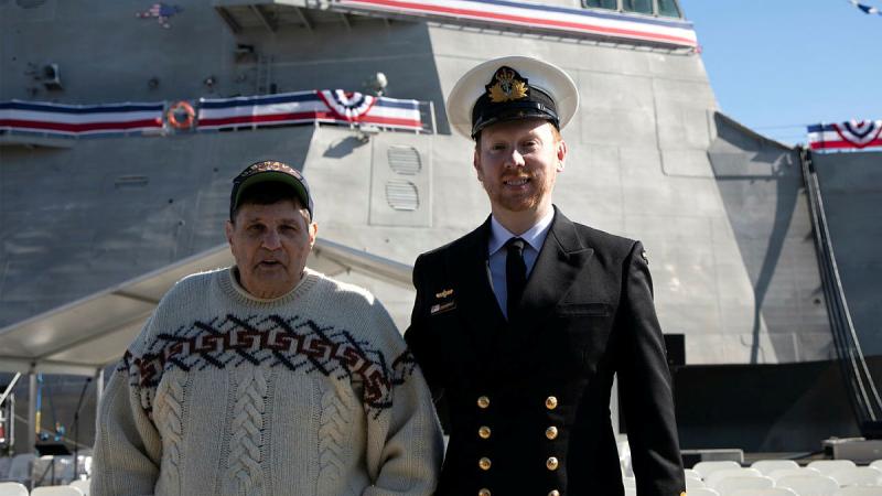 Lieutenant Ryan Tyrrell, right, and his stepfather Marty Wollins in front of USS Canberra during its commissioning at Fleet Base East, Sydney. Photo: Petty Officer Helen Frank