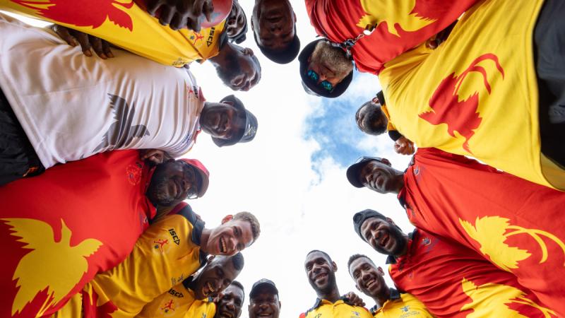 Local participants form a huddle during an ADF Sports training program at the Sir John Guise Stadium, Port Moresby, Papua New Guinea.