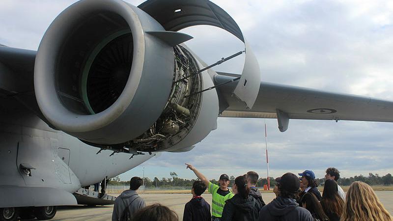 A group of AYAF delegates in front of a Globemaster wing. 